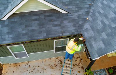 Gutter cleaning technician working on Tacoma, WA home
