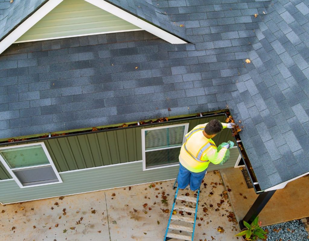 Gutter cleaning technician working on Tacoma, WA home