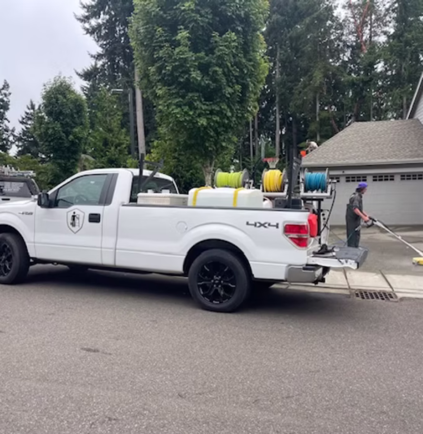 Driveway being cleaned with professional pressure washing equipment